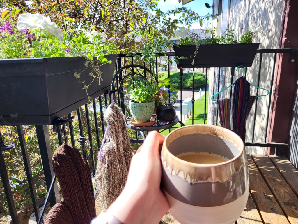 Sunny porch with white and purple petunias in a flower boxes. 
